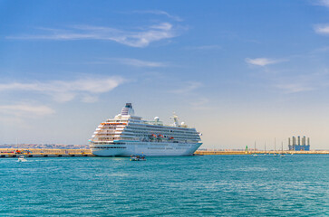 Grand cruise ship moored near pier in harbor Port of Alicante Puerto de Alicante, white cruise ship voyage in Mediterranean Sea water Alicante bay, concept travel on holiday, vacation summer, Spain