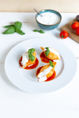 Traditional Italian Conchiglioni pasta with Italian Cheese, Tomato Sauce, and Basil Leaves