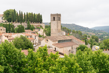 Historic buildings and lush greenery adorn Brihuega in Guadalajara, Castilla-La Mancha, Spain on a cloudy day