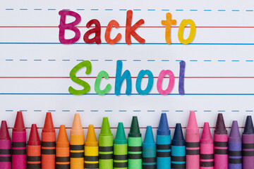 Back to School with crayons with ruled loose leaf paper
