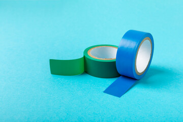Insulating tape on a bright colored background. Set of different colors insulating tape. Reel...