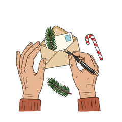 Hands writing a letter with a candy cane and pine needles  