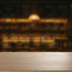 Blurred atmospheric bar with empty wooden table in the foreground, ideal for product display or...