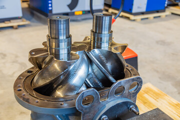 Shiny new screw compressor rotors showing engineering precision