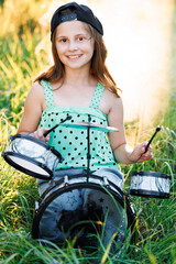 Portrait Young Female Playing Drums During a Band Rehearsal with Warm Sunlight at Daytime. Drummer...