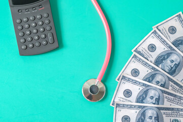 A dollar bills with calculator and a stethoscope , Paying more for your health concept.