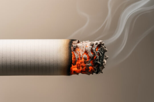 Close-up of burning cigarette with glowing ember and rising smoke symbolizing addiction and health risks - Powered by Adobe