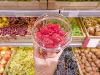 buying fruits and  berries ( raspberries, blueberries, strawberries, gooseberries)at the market