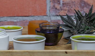 Home made marijuana medical salve with color brick wall