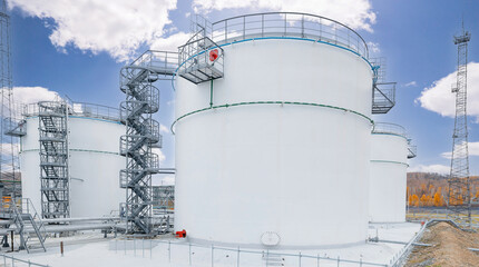 Modern oil fuel storage tank against blue sky