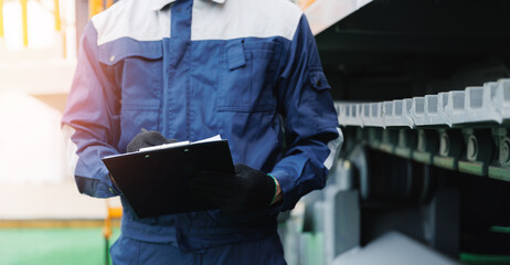 Industrial service banner, worker with clipboard recording data in mining site with machinery in...