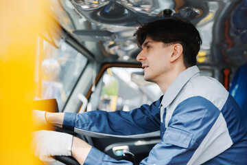 Caucasian male adult driving mining vehicle in industrial setting