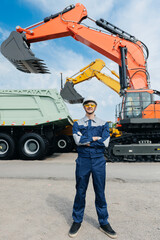 Portrait Male worker foreman in front of excavators and dump truck in mining industry scene