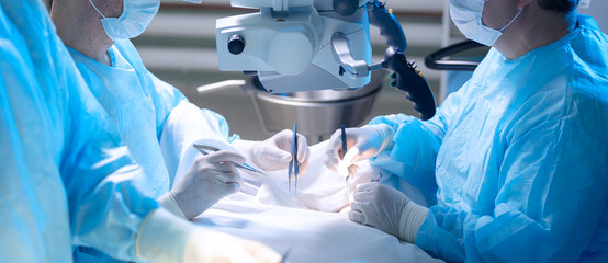 Group of surgeons at operation in operating room at hospital. Concept Medical urgent treatment,...