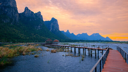 Panorama landscape wooden bridge over lotus lake at sunset in khao sam roi yot national park,...