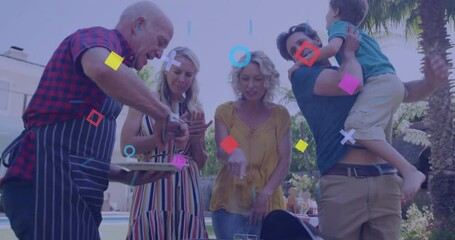 Culinary family sampling grilled vegetables as senior man flipping skewers sparking confetti party - Powered by Adobe