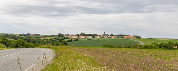 Road along Opal coast with sea view and little village with white houses in Northern France
