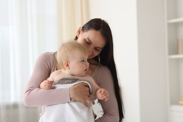 Mother with her cute baby at home, space for text