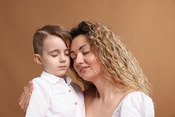 Family. Mother and her son on beige background