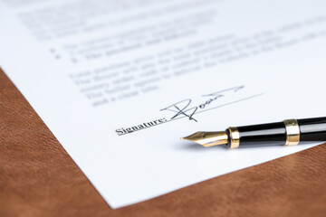 Notary document and fountain pen on brown leather surface, closeup