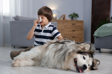 Boy suffering from allergy with her dog at home