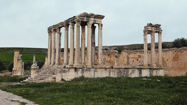 View of historical Temple of Juno Caelestis with columns and ruined stone walls in Dougga, Tunisia