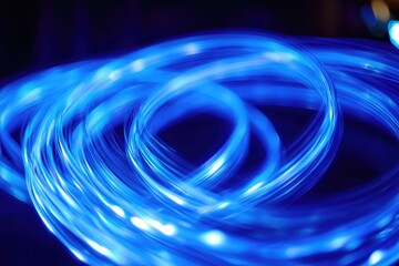 Abstract blue light swirls on dark background