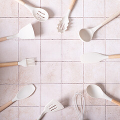 kitchen set spatulas ladle on tile background