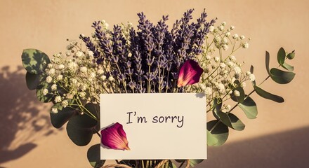 A heartfelt bouquet with a note expressing "I'm sorry," conveys sincerity and regret amidst delicate flowers and foliage.