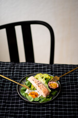 Salmon fish steak grilled, avocado and fresh vegetable salad. Ketogenic diet. Low carb high fat breakfast. Healthy food concept.