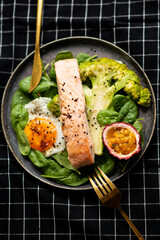 Salmon fish steak grilled, avocado and fresh vegetable salad. Ketogenic diet. Low carb high fat...