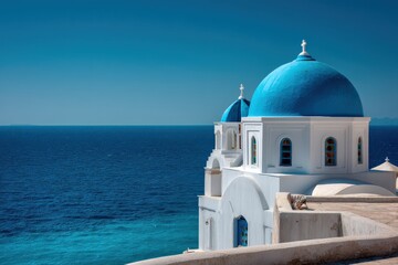 Obraz premium Stunning blue-domed church overlooking a tranquil ocean.