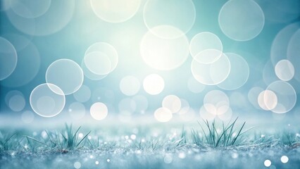 Soft bokeh lights over dewy grass blades in cool blue tones