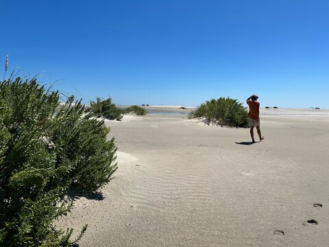 Boy walking along dunes in Outer Banks beach