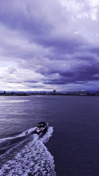 Wakeboarding Behind Boat on Tamsui River | Aerial Drone Footage in Taiwan (Cloudy Sky)