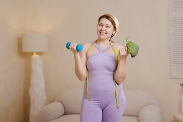 Happy Plus Size Woman with Dumbbell and Broccoli Fitness Weight Loss Healthy Eating and Sports Concept