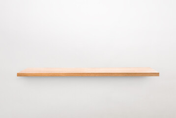 one wooden wall shelf on gray wall