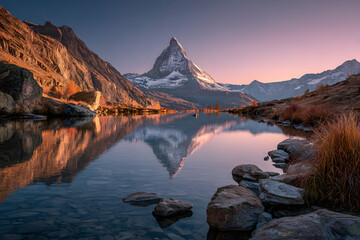 Obraz premium Stellisee lake glows at sunset with perfect Matterhorn reflection in clear alpine water. Swiss Alps evening view near Zermatt with golden light and snowy peak