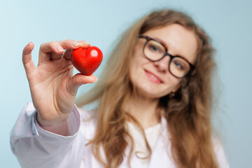 Female Doctor Holding Red Heart Symbol Promoting Cardiovascular Health and Medical Care