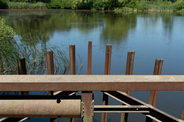 A rusted part of the lifting mechanism of an old dam	
