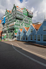 Obraz premium This captivating photo showcases the unique, stacked traditional Dutch house architecture of the Inntel Hotels in Zaandam, blending classic style with modern design under a dramatic sky.