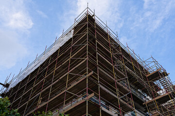 Scaffolding surrounding residential development for safe access to construction work
