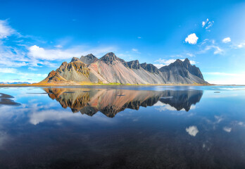 Impressive  sunny day and gorgeous reflection of Vestrahorn mountaine on Stokksnes cape in Iceland.