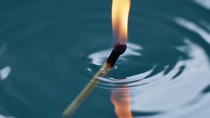 Burning match in water Flame and reflection with abstract concept. - Powered by Adobe