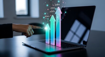 A hand points to growth arrows rising from a laptop screen on a dark desk in a modern office