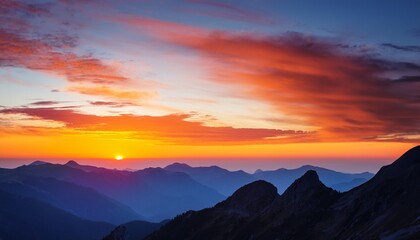 Fototapeta premium vibrant sunset over mountains with colorful sky and silhouetted peaks