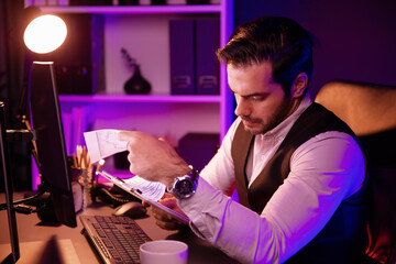 Serious smart businessman focusing on paperwork report folder analyzing sales channel discipline's...