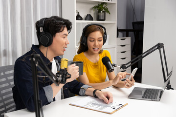 Smiling radio influencer hosts wearing headphones with channel social media online live streaming...