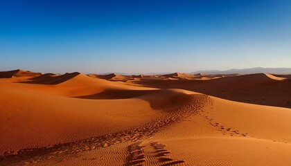 vast desert with high sand dunes clear blue sky camel tracks