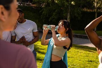 Friends hydrating during outdoor exercise